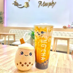 a cup of bubble tea and a plush toy