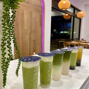 a row of cold drinks on a counter