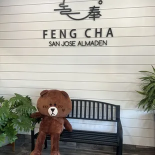 a teddy bear sitting on a bench