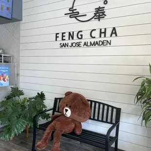a teddy bear sitting on a bench