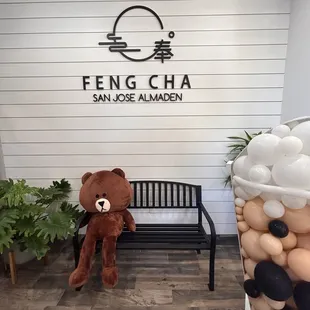 a teddy bear sitting on a bench