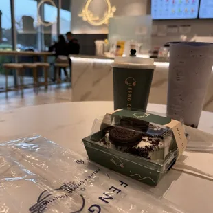 a cup of coffee and a piece of cake on a table