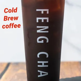 a cold beverage with coffee beans