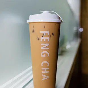 a cup of coffee on a window sill