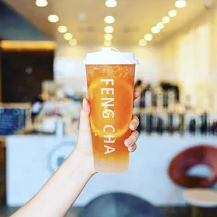 a person holding a cup of tea