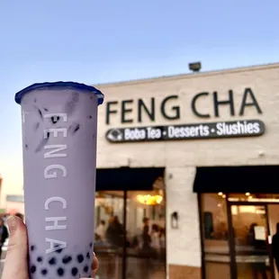 a hand holding a cup of bubble tea