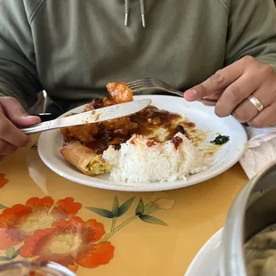 a man sitting at a table with a plate of food