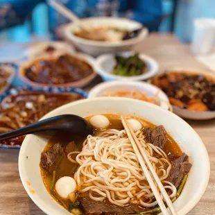 a bowl of soup with chopsticks