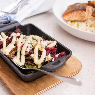 Crispy Brussels Sprouts topped with goat cheese, dried cranberries and pesto aioli (contains nuts).