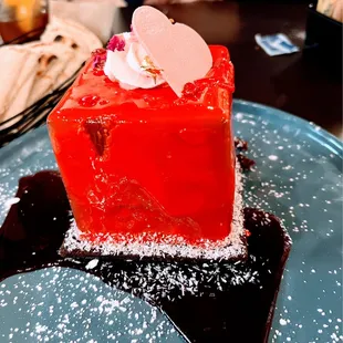 Chocolate mousse crunch cake with raspberry sauce