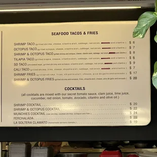 a menu for seafood tacoss and fries