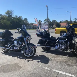 two motorcycles parked in a parking lot