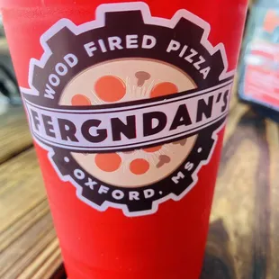 a red cup on a wooden table