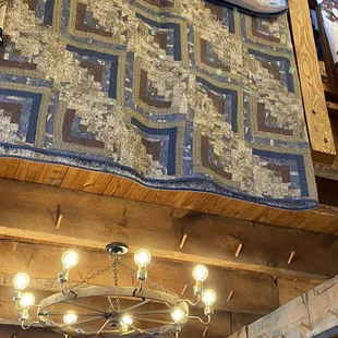 a quilt hanging from the ceiling