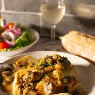a plate of food and a glass of wine