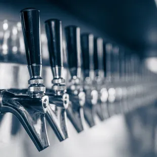 a row of beer taps