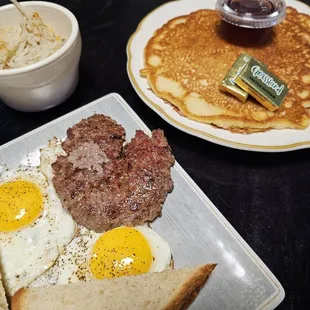 Classic Fern, 2 sunny side up eggs, sausage patty, bowl of home fries, wheat toast, and 2 buttermilk pancakes.