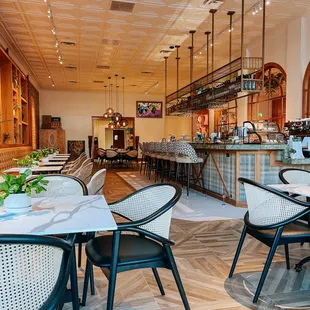 a dining area with tables and chairs