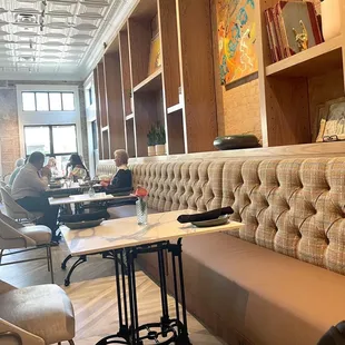 people sitting at tables in a cafe