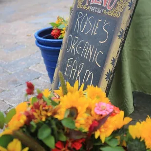 a menu sign and flowers