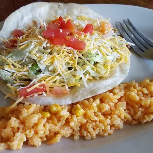 Lunch soft taco with a side of rice.