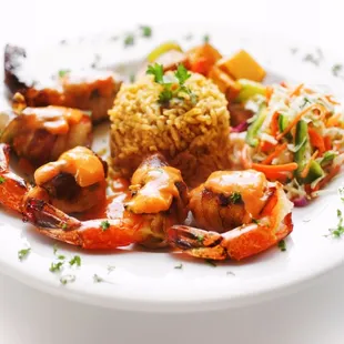 CAMARONES COYOACAN Fresh jumbo shrimp filled w/ crabmeat, herbs, breadcrumbs, baked w/ white wine sauce, w/ rice and grilled vegetables