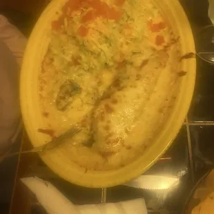 Chicken enchiladas with a side of beans and rice