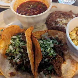 Birria tacos with a side of elote and frijoles