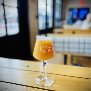 a glass of beer on a table