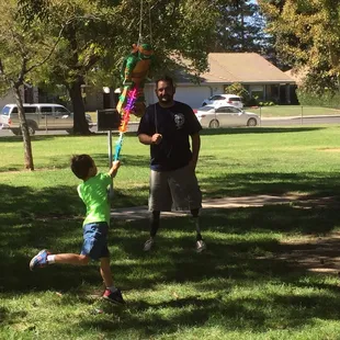 Piñata time with birthday boy's dad. He had both legs blown off in Afghanistan.