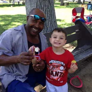 Showing off his medal to Pastor Ike at our church picnic.