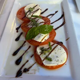 a plate of tomatoes and mozzarella