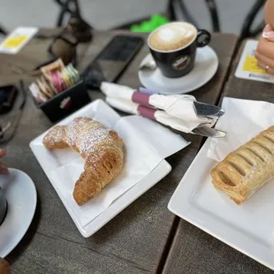 a couple of plates of pastries and a cup of coffee