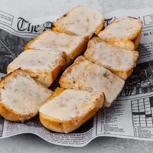 a close up of a piece of bread on a newspaper