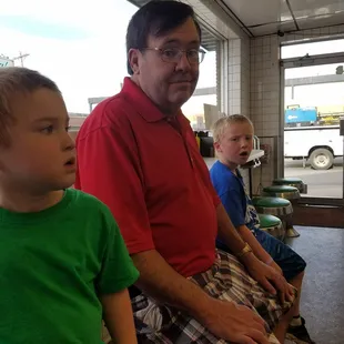 a man sitting in a waiting area with children
