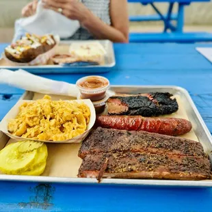THE TEXAS TRINITY  Brisket, 2 smoked spare ribs, sausage link, BBQ Mac and Cheese