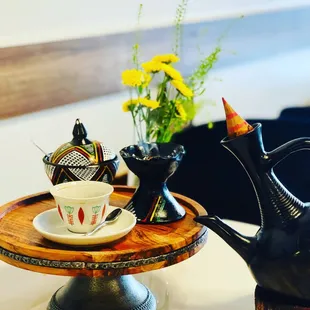 a teapot and a cup on a table