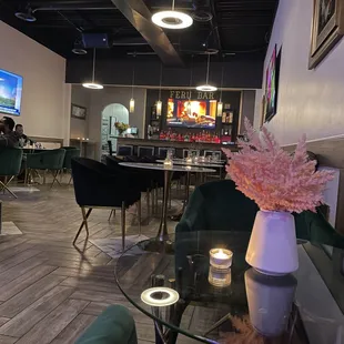 a glass table with a vase of flowers on it