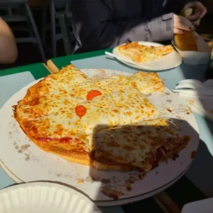 A Pepperoni Pizza with a side of shadow.
