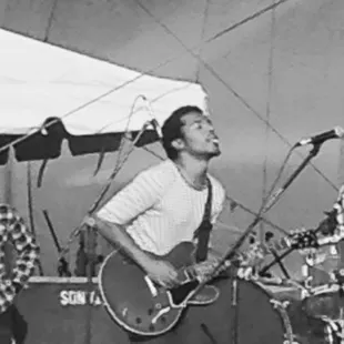 a man playing guitar and singing