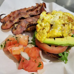 bacon, eggs, avocado, tomato, and tomato salad