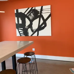orange walls with black and white artwork