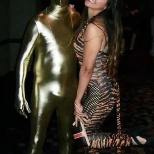 a woman posing with a gold man