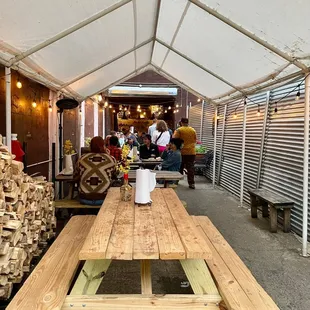 a wooden picnic table in a tent