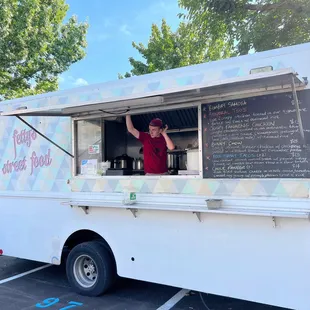 a man standing at a food truck