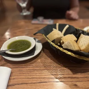a basket of bread sticks and a bowl of soup