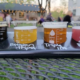 five different beers on a tray