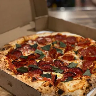 Pepperoni, basil, and light garlic sprinkled on it.