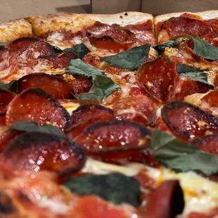 A close up of the pepperoni and sausage pizza.