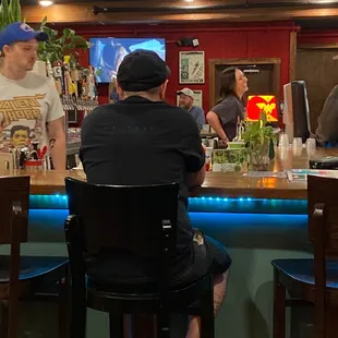 It's a bar with a movie theatre and pizza place attached? Or is it a theatre with a pizza place and bar? Who knows?